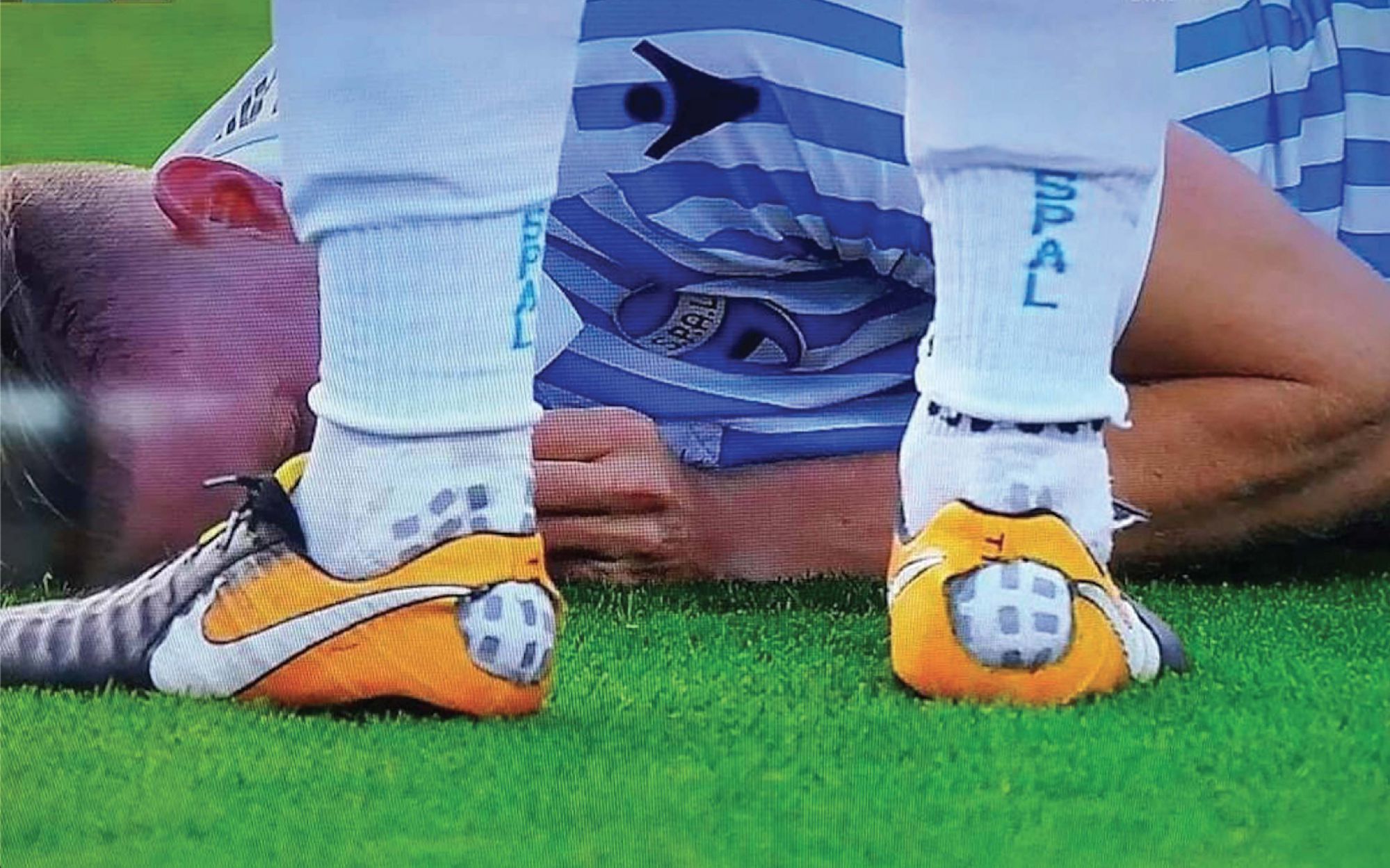 Why do footballers cut holes in their socks?